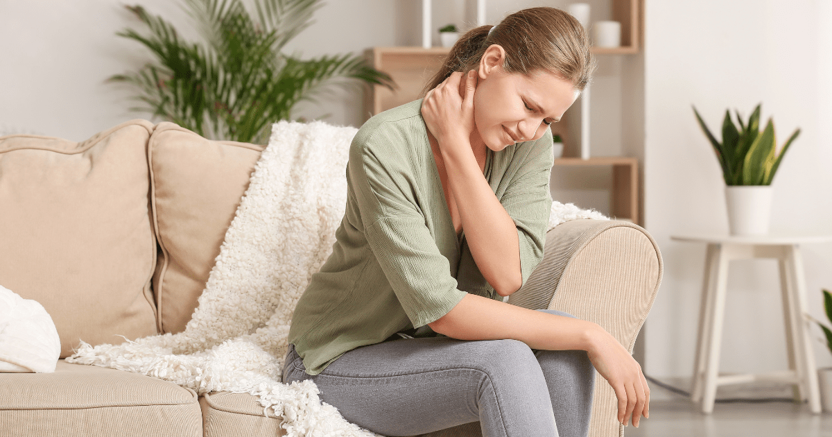 Woman holding her neck after being injured and enduring pain and suffering.